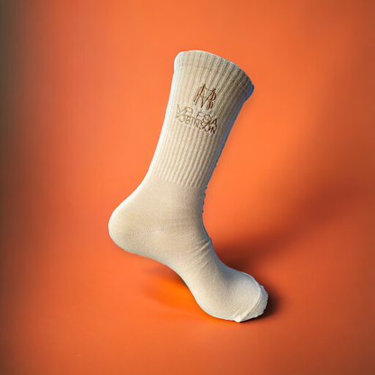 Calf-high knit stretch cotton-blend socks in beige. Logo embroidered at rib knit cuffs.